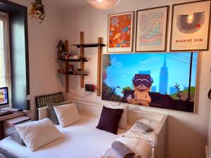a room with a bed and a large screen at OW, by A&J - Familj & Bilen & Hunden - Liseberg & Avenyn! in Gothenburg +24 photos