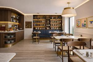 a restaurant with tables and chairs and a bar at Hôtel Beauvoisin in Paris