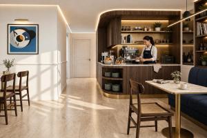 a woman standing at a counter in a coffee shop at Hôtel Beauvoisin in Paris