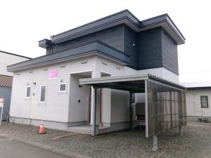 a large white building with a large entrance at 愛灯-ｉｔｏ- in Kami-furano