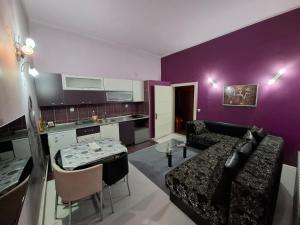a living room with a couch and a table at Apartmani Pelivan in Soko Banja