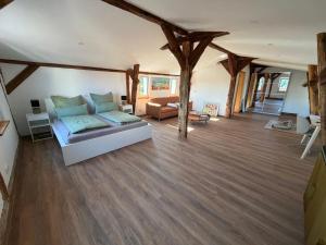 a living room with a couch and wooden floors at Doppelapartment alte Bäckerei in Feldberg