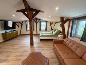 a living room with a couch and a table at Doppelapartment alte Bäckerei in Feldberg
