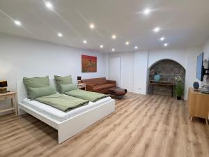 a bedroom with a bed and a living room at Doppelapartment alte Bäckerei in Feldberg +17 photos