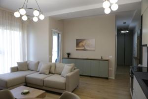 a living room with a couch and a table at Boulevard View in Tirana