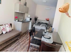 a small living room with a table and a couch at Bogdanovi Guest House in Chernomorets