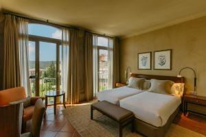 a hotel room with a bed and a large window at Hotel Bremon by Grup Duquessa in Cardona