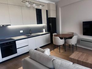 a kitchen and living room with a couch and a table at Boulevard View in Tirana