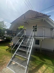 a staircase leading to a house with a roof at Haus am Murgtalpfad 1 und 2 in Rickenbach