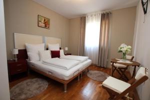 a bedroom with a bed with white pillows at Elegant Villa Hariz near Poreč - Fully AC & Large Pool in Gedići