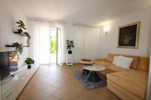 a living room with a couch and a table at Elegant Villa Hariz near Poreč - Fully AC & Large Pool in Gedići