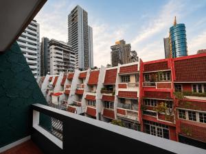a building with red roofs in a city at Beyond Stay Thong Lor 11 in Bangkok