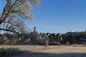 a large field with a town in the background at Ferienwohnung am Lennepark in Schmallenberg