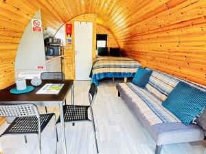 a room with a couch and a table and a bed at Brora Escapes in Brora