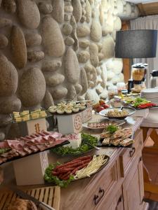 a buffet with plates of food on a table at Willa Dunajec in Zakopane +67 photos