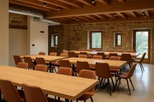 a large room with tables and chairs in it at Solatsu Baserria - Apartamentos Rurales in Elorrio +58 photos