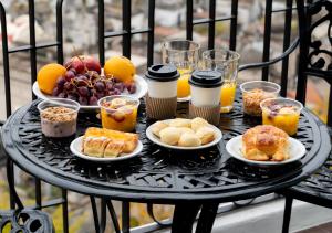 a table topped with plates of food and fruit at Reco by DOT Suites in Buenos Aires