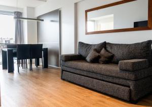 a living room with a couch and a table at Reco by DOT Suites in Buenos Aires