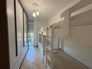a hallway with bunk beds in a room at Near movenpic apartament in Draç +1 photo