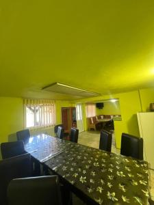 a conference room with a long table and chairs at Cabana Adelin in Dobreşti