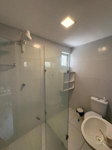 a bathroom with a glass shower and a toilet at Residencial Sol - Cidade alta in Natal +16 photos