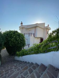 a white house with bushes in front of it at B&B Le Giadali in Praia a Mare