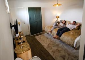 two people laying on beds in a hotel room at Bambou Zen Room in Rang-du-Fliers