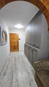 a kitchen with wooden cabinets and a wooden door at Dereboyu Premium in Nicosia +46 photos