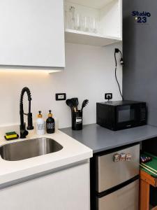a kitchen with a sink and a microwave at Studio B23 Azure North in San Fernando +11 photos