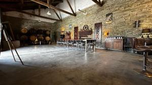 a room with a table and chairs in a wine cellar at QUINTA da CASA CIMEIRA - Douro Wine State, A House of Wine, Food & Memories in Valença do Douro