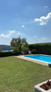 a swimming pool in the yard of a house at Villa Oleandri pool with view-BGL in Salò