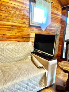 a laptop computer sitting on a bed in a room at House by the river in Ptuj