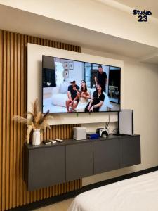 a room with a flat screen tv on a wall at Studio B23 Azure North in San Fernando