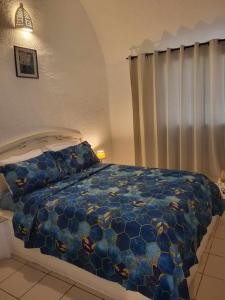 a bedroom with a bed with a blue comforter at summer kif in Nabeul