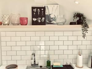 a kitchen counter with white subway tiles and a sink at Derbyshire House Apartment 3 - Cavendish in Buxton +38 photos
