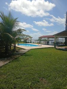 a resort with a swimming pool and a gazebo at Pousada Don Melo in Salvaterra