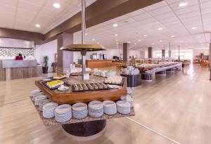 a restaurant with a buffet of food on display at Hotel Natura Park in Comarruga