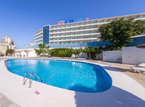 a large swimming pool in front of a building at Hotel Natura Park in Comarruga