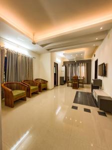 a large living room with couches and a piano at Grand Retreat in Trichūr