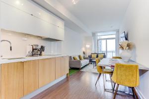 a kitchen and living room with a table and chairs at Lakeview 1 Bed 1 Den by Rogers Centre in Toronto
