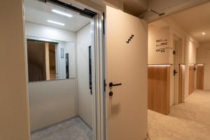 a hallway with a door leading into a room at The CORNR Seaview in Nieuwpoort +85 photos