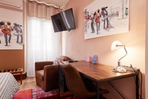 a desk with a lamp and a chair in a room at hotel de la paix in Pamiers