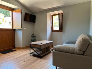 a living room with a couch and a table at Pensión Eirín VI in Caldas de Reis