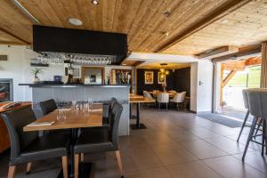 a restaurant with tables and chairs and a bar at Le Flocon d'Argent in Les Gets