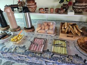 a table with different types of food on it at Pousada Don Melo in Salvaterra
