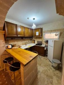 a kitchen with wooden cabinets and a white refrigerator at Wanderlust Inn Cappadocia in Uçhisar
