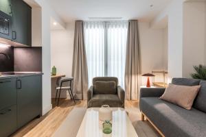 a living room with a couch and a chair at Cauce 4 Apartments in Torremolinos