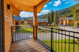 a view from the porch of a cabin with a view of the mountains at Stylish Loft Apartment with Mountain View near the Lake in Afritz +36 photos