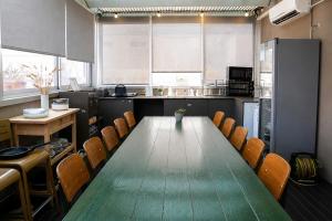 a conference room with a long table and chairs at Florentin House with MAMAK - By HOMY in Tel Aviv