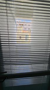 a view of a building through the blinds of a window at Dereboyu Premium in Nicosia